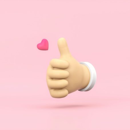 Un pouce levé symbolisant des clients heureux de leurs créations. Un pouce levé avec un cœur rose sur fond rose.